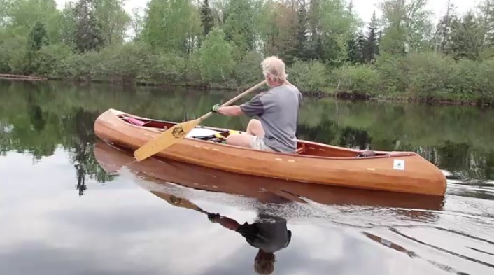 Peter in a canoe with a paddle